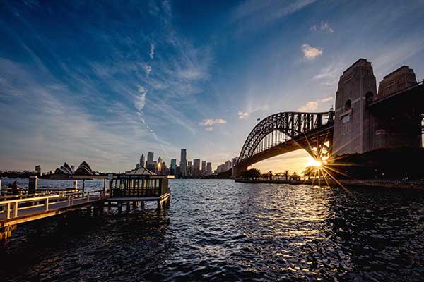 bridge-crossing-a-body-of-water-at-sunset-in-sydne-2023-12-29-02-41-56-utc